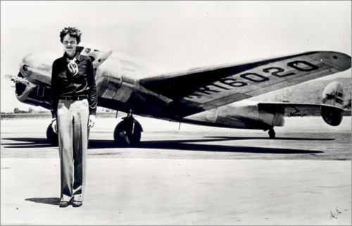 Amelia Earhart and One of Her Many Planes
